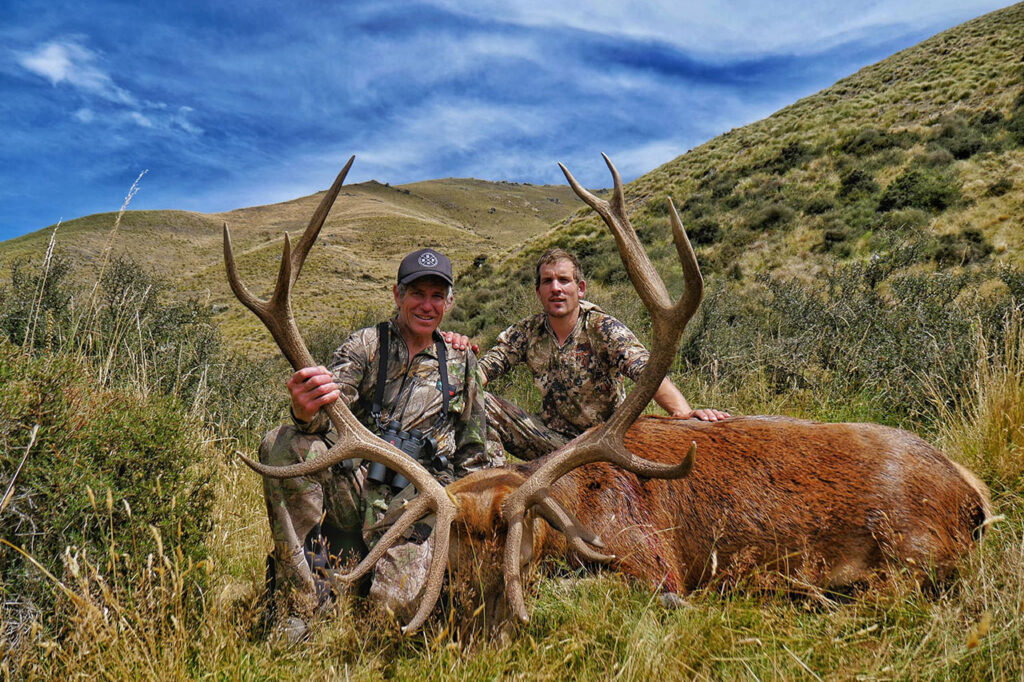 hunters posing with their trophy hunt